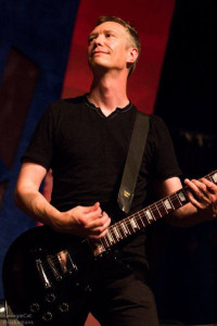 Derek Harding on stage playing guitar
